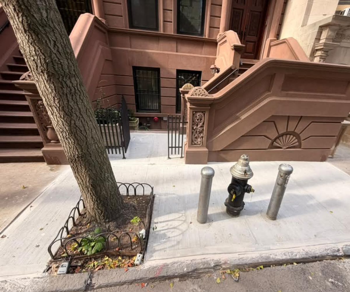 Completed concrete sidewalk and brownstone frontage at 314 W 81st Street with street tree and fire hydrant