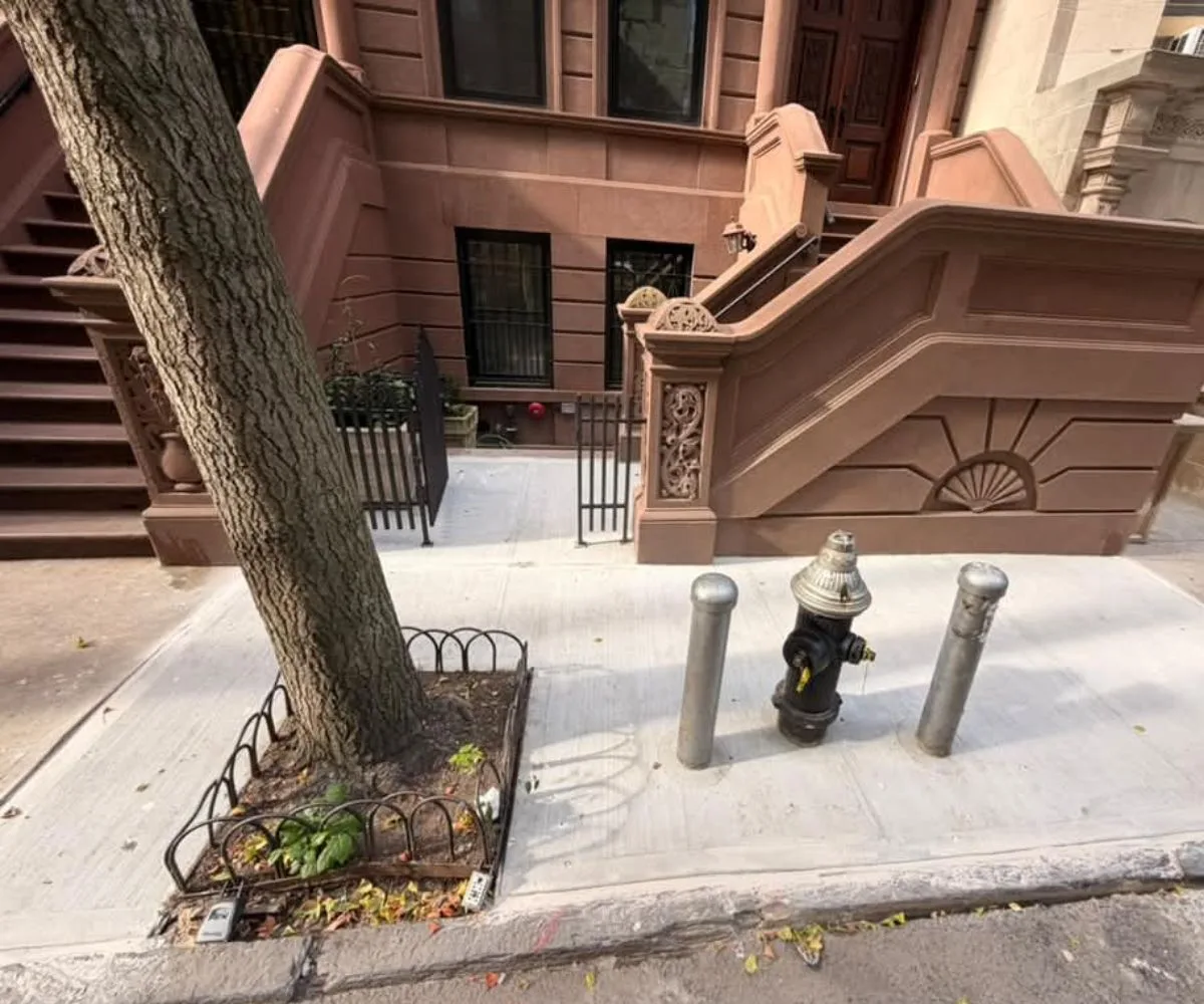 Completed concrete sidewalk and brownstone frontage at 314 W 81st Street with street tree and fire hydrant